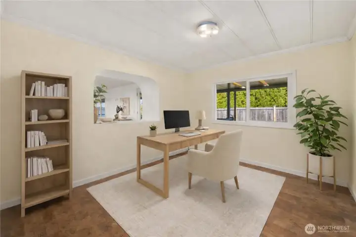 A versatile bonus space with water views offers the perfect setting for a home office, creative retreat, or quiet escape inspired by the coastal surroundings.             (photo virtually staged)