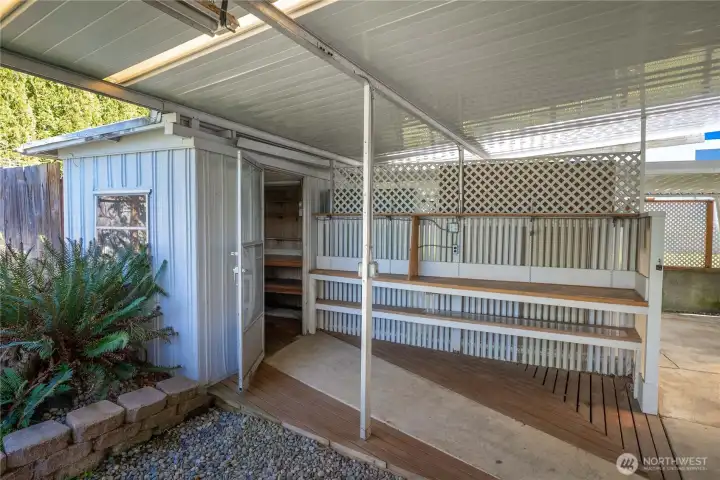 A covered potting area complete w/built-in shelving offers the perfect space for gardening, planting, and enjoying your outdoor hobbies year-round.