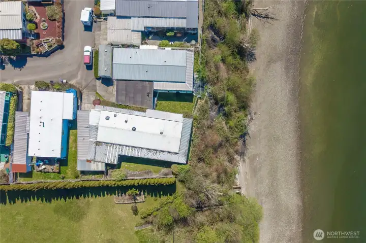 Aerial view highlights the home’s close proximity to the shoreline and community beach, bringing the coastal lifestyle full circle.