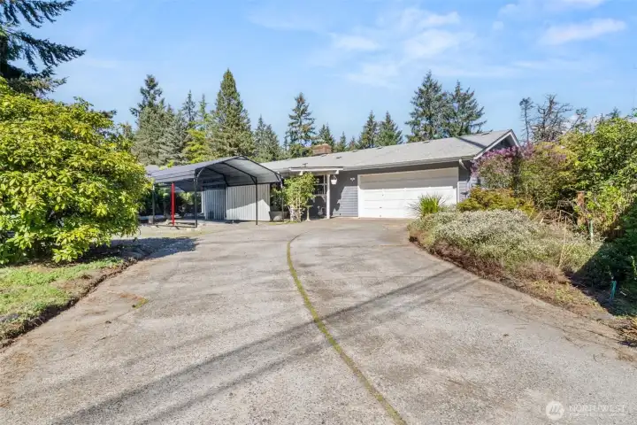 Rear access drive into the double garage and a perfect cover for your boat or RV. You walk into the kitchen from the garage.