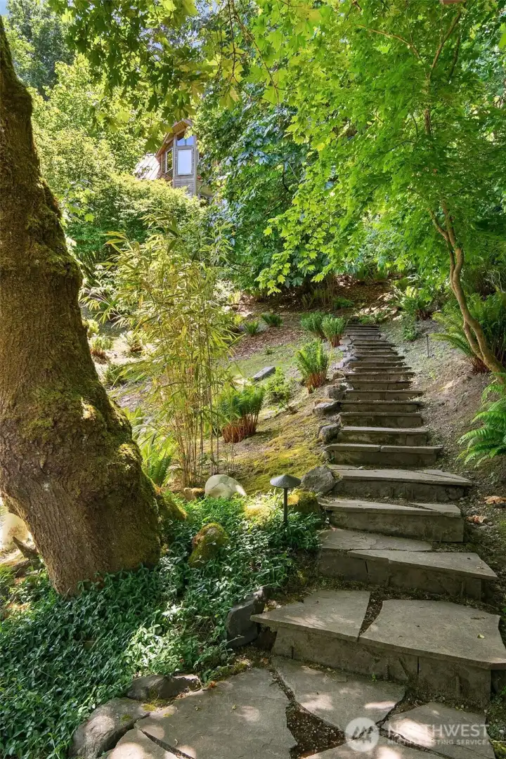A magical stair carries you up to the gem-like cottage above the beach.