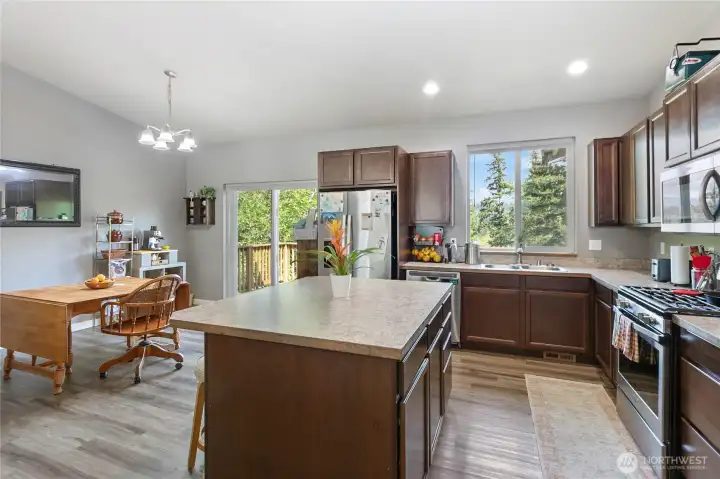 Main floor common area & kitchen w/ vaulted ceilings