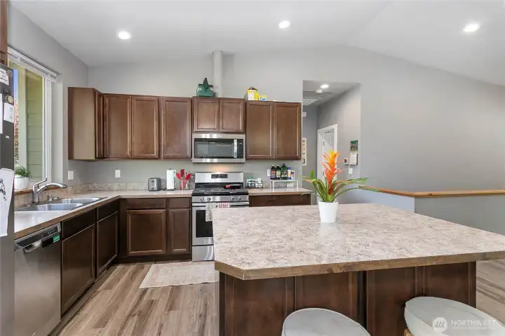 Main floor common area & kitchen w/ vaulted ceilings