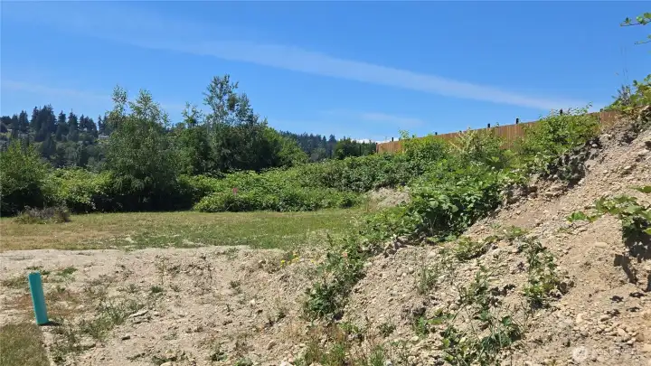 building site with extra dirt for buyer to use.