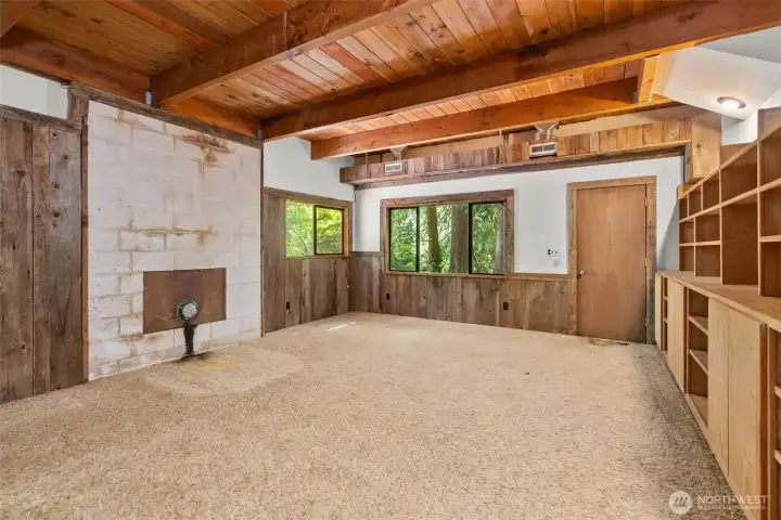 Family room with custom shelving and door to the backyard.