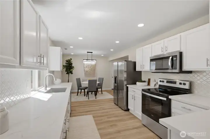 Quartz countertops steal the show. Designer backsplash, endless inspiration. Stainless steel appliances complete the space.