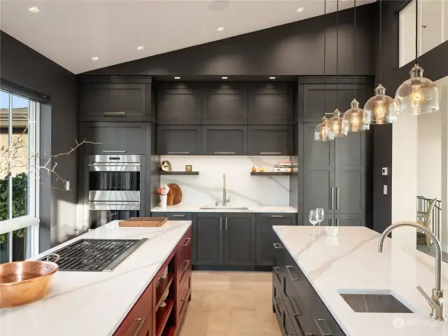 The kitchen is complete with a suite of SubZero, Miele and Wolf appliances, and two islands for seating, cooking, and mingling—one with a prep sink, the other with a range cooktop.
