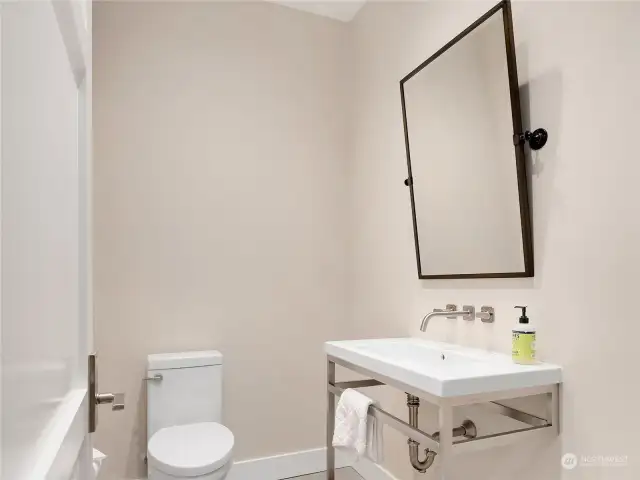 A convenient bathroom with custom Italian sinks and modern appointments.