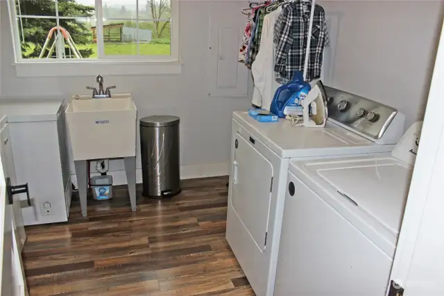 Large utility room accomodates a utility sink and 2 freezers.