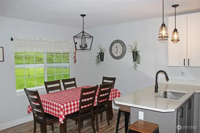 Dining area with picture window views to the front yard and fruit trees