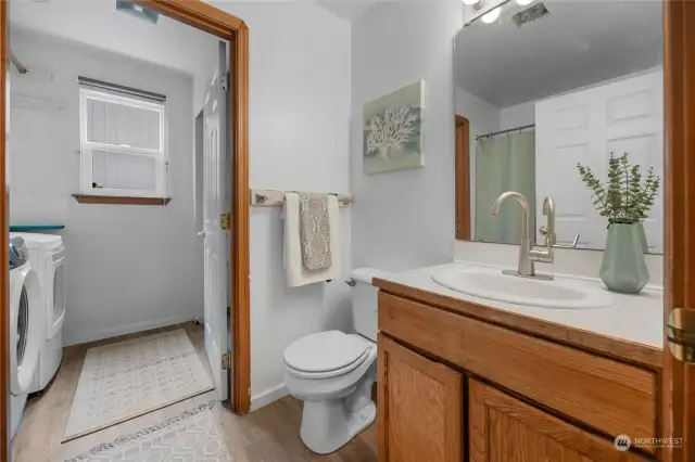 Lower-level full bath and laundry area. Tub/shower is to the left of the picture.