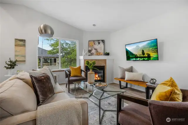 Living area with the gas fireplace pulls the entire space together and instantly adds an inviting warm feel. TV is yours to keep if you so desire