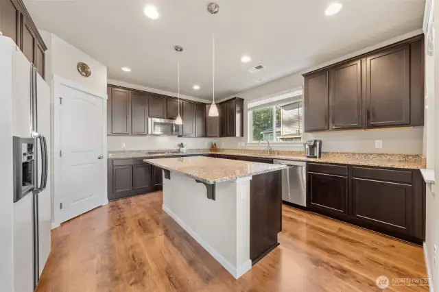 Large island with seating, and a walk-in pantry.