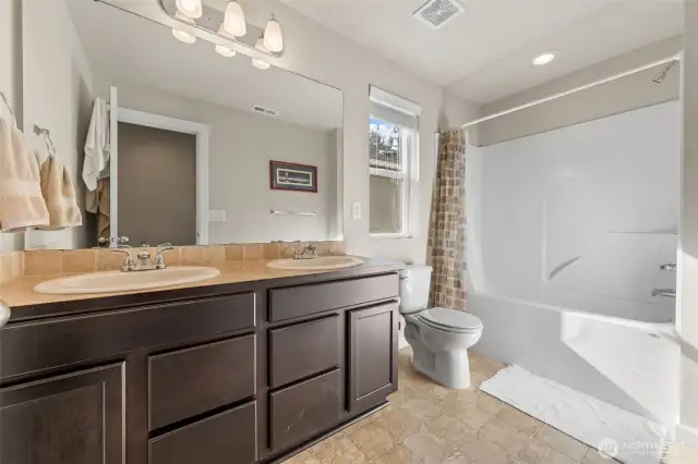 Upstairs Shared Bathroom – Features a double-sink vanity for added convenience.