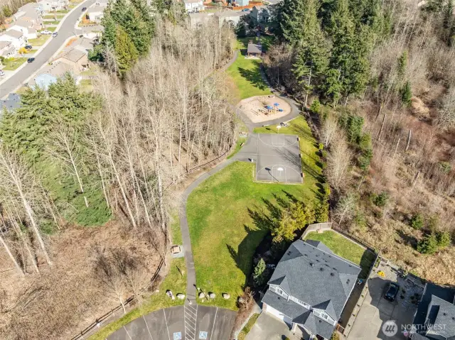 Community Amenities – Summerwood Park features a sports court, playground, paths, picnic area, and open lawns.