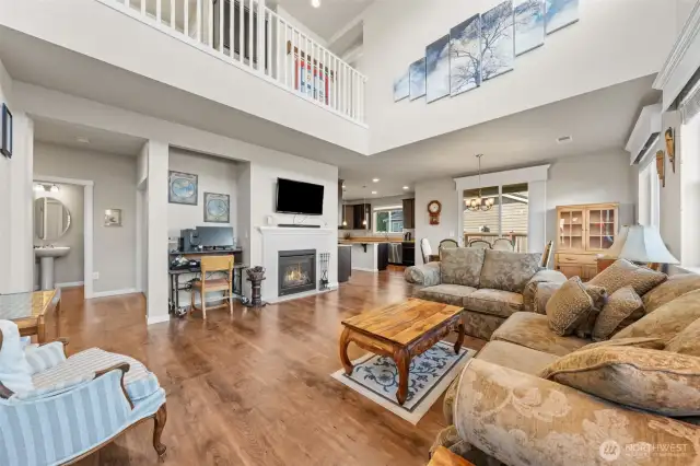 Expansive Living Space – Soaring double-height ceilings flood the room with natural light.