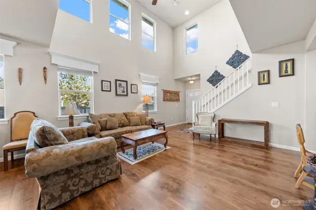 Wall of Windows in the Living Room – Floods the space with natural light, enhancing the open and airy feel.