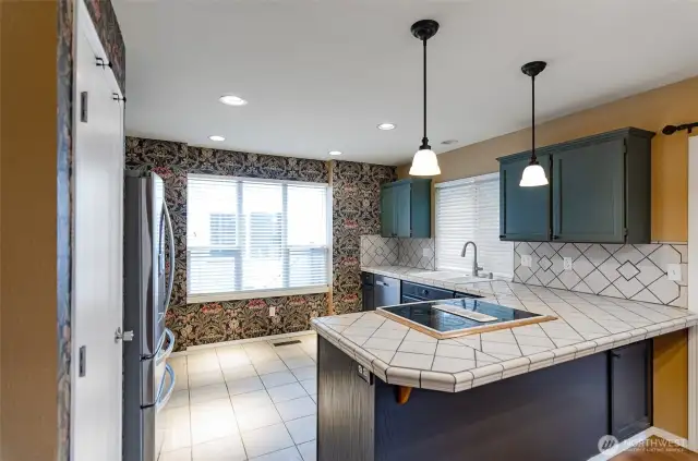 Spacious kitchen has tiled floors