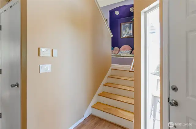 Stairs to the upper level has a seating nook, perfect for a place to read.