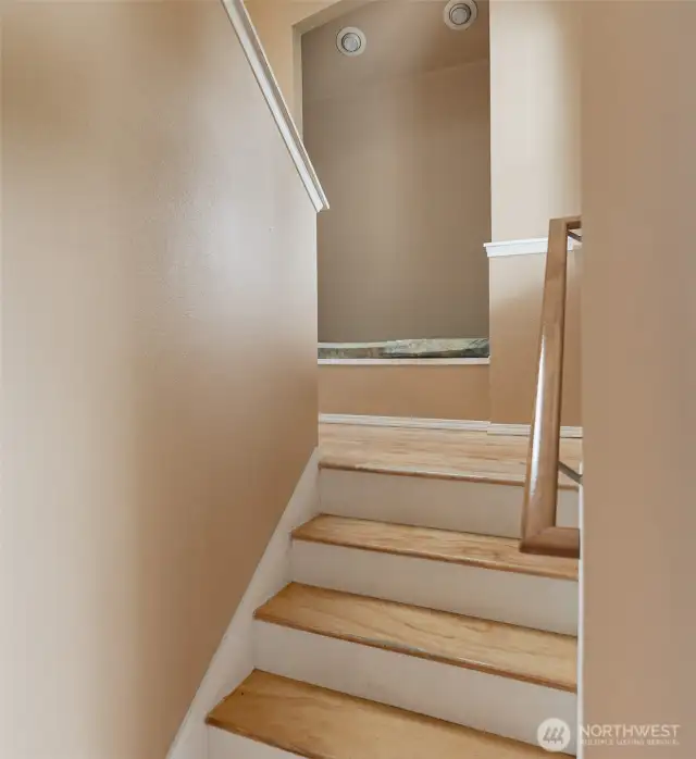 Stairs leading to the upper level has a seating nook.