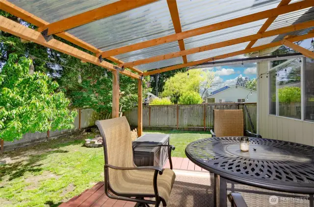 Light filtering covered back deck offers enjoyment in any weather.