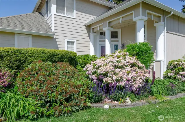 Covered are by entry is a private little oasis screened by the mature plantings.