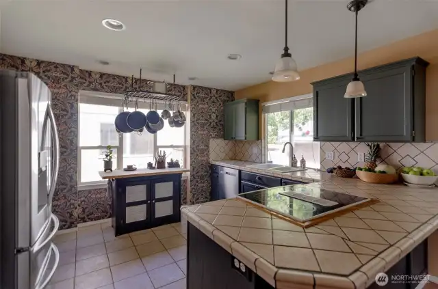 Kitchen with eating space. Tiled floors. Newer refrigerator and dishwasher.