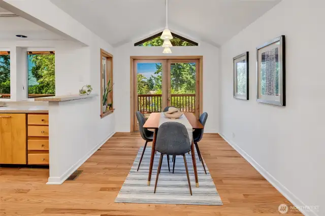 Dining room features vaulted ceilings to the French Doors to the deck
