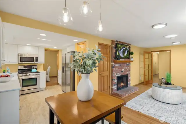 A nice breakfast nook, easy to engage with folks in the kitchen, or alongside in the family room - complete with wood burning fireplace!  Pocket door from dining to kitchen, and glass door from family room to entry allow you to close off this section, creating various spaces for various people - entertain the grown ups in the living room while kids can hang out in the family room!