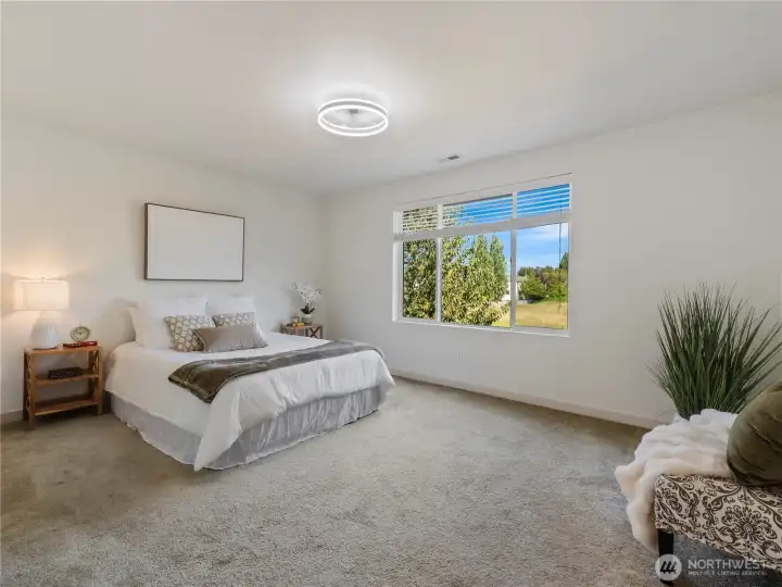 The primary bedroom on the upper level is spacious and faces east, capturing the morning sun.