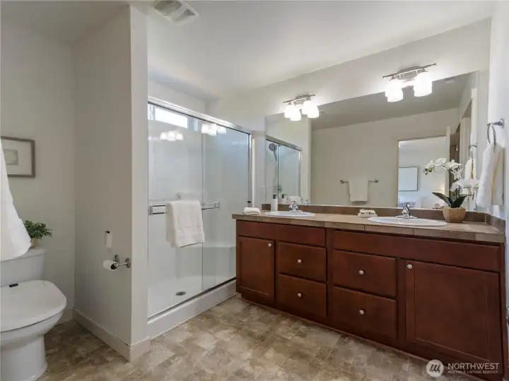 The primary bedroom's ensuite has an extended shower and dual sinks.