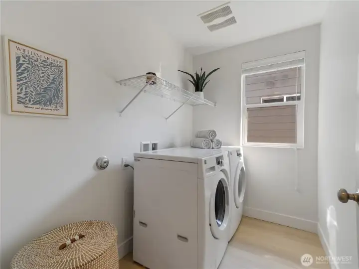 Laundry room with front load washer & dryer, conveniently located on the upper level.