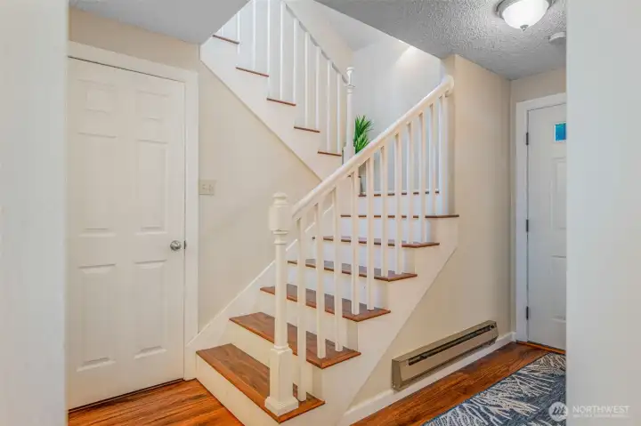 Large storage & Coat closet with grand staircase.