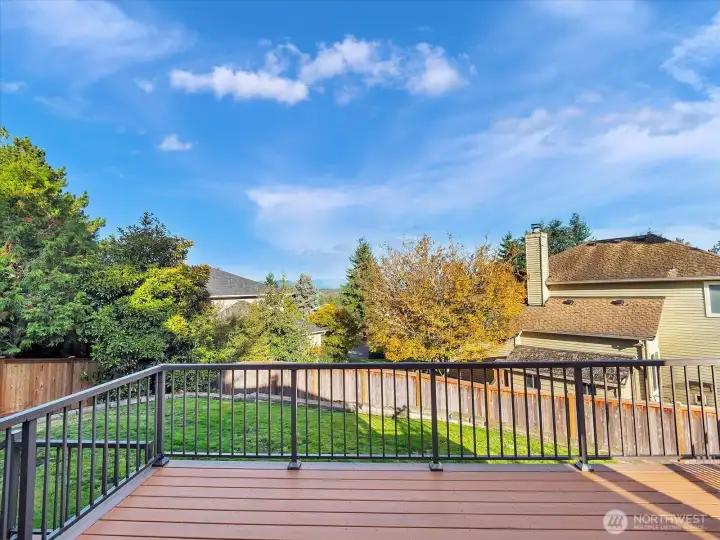 Expansive trex deck with Cascade views and lawn.