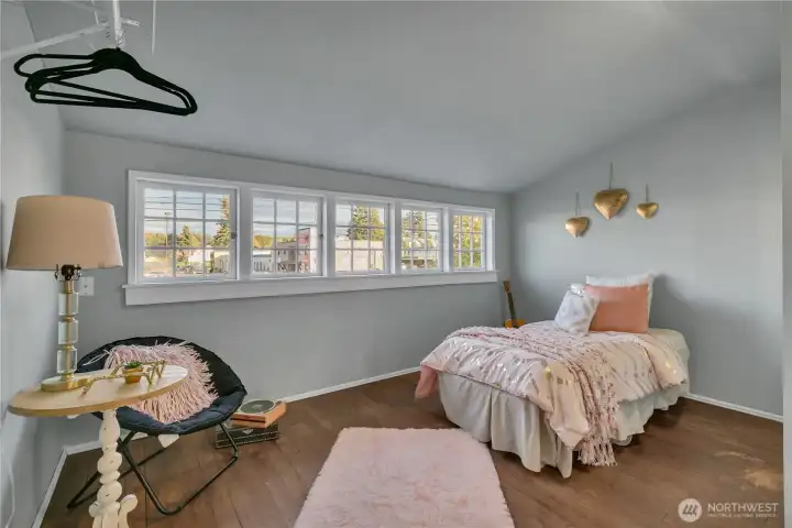 Upper-level bedroom with a wall of multi-pane windows. Upper-level bedroom with a wall of multi-pane windows.