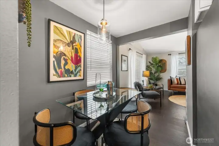 A beautiful statement light fixture hangs from the ceiling, enhancing the dining area with style and warmth.