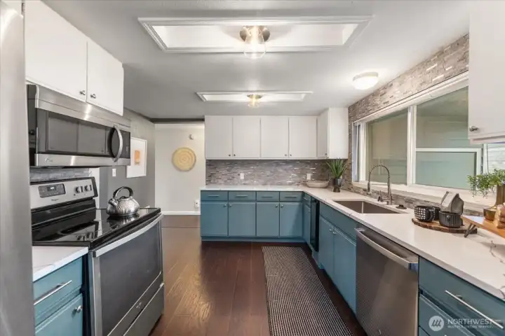 Enjoy an updated kitchen with quartz countertops and a coordinating tile backsplash, creating a bright and inviting cooking space.