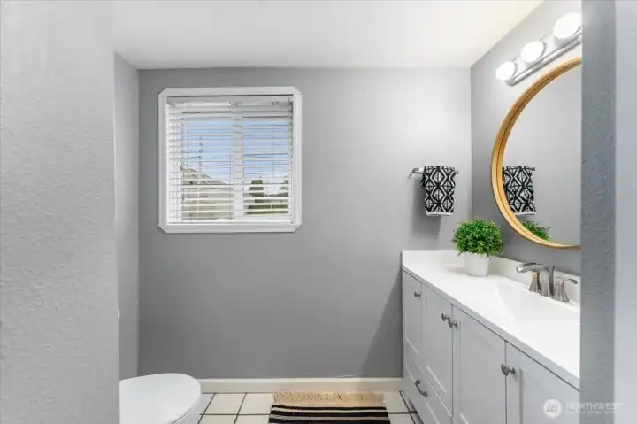 Enjoy a stylish full  bathroom with durable tile floors, quartz countertops and ample cabinet space for all your storage needs.