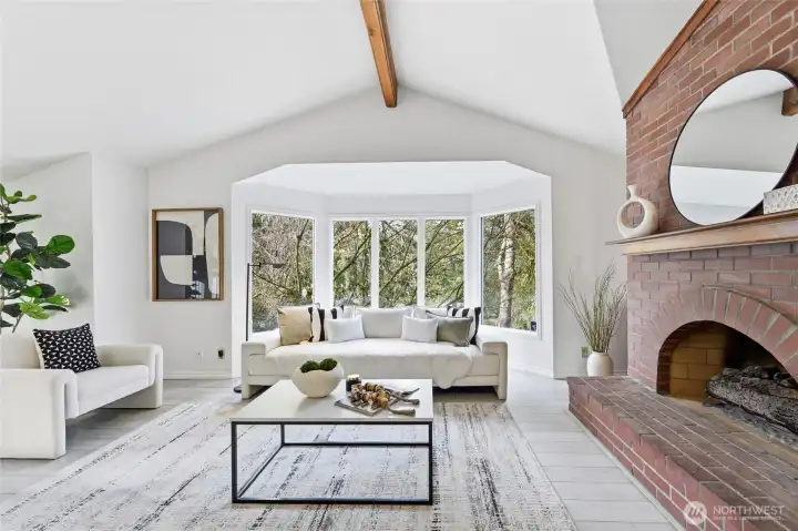 The living room has a gas fireplace and garden windows that look out to the front yard.