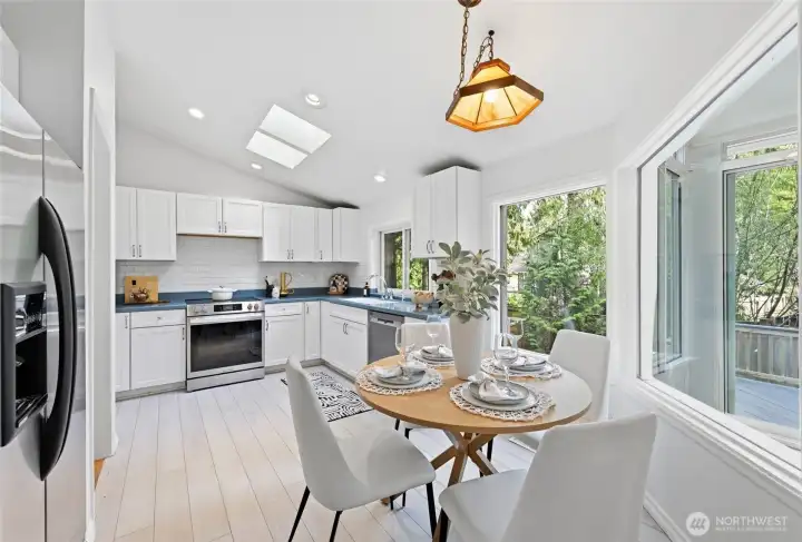 The kitchen has cathedral ceilings, skylights and big windows facing the back yard.
