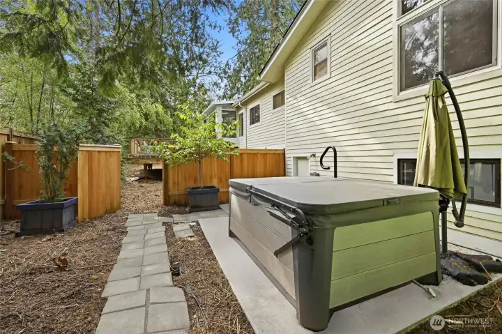 The backyard is fenced in two separate sections with a gate connecting the two spaces.
