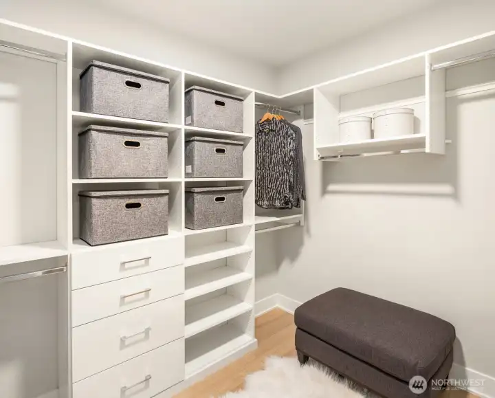 Custom walk-in closet with built-in shelving and adjustable storage organization.