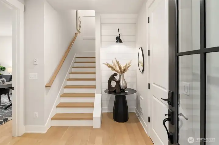 Welcoming main entry foyer with wide-plank white oak flooring and modern farmhouse details.