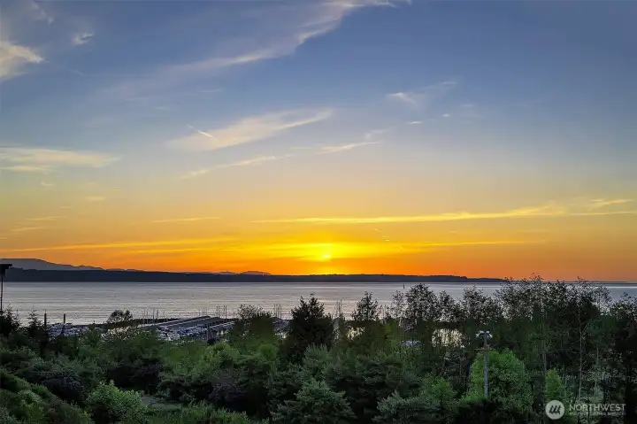 Sunsets warm the sky as you relax on your spacious, sun-drenched deck with coveted southern exposure.