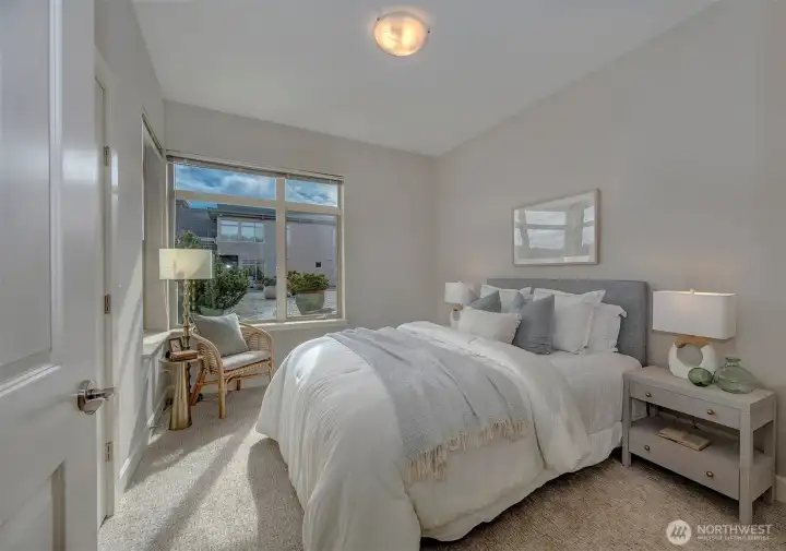 Guest bedroom is light filled and spacious with a large walk-in closet.