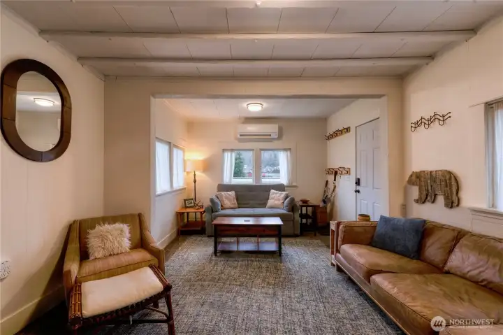 Welcome to your cozy living space w/abundant natural light, leather couch, sleeper sofa, vintage chair, coat racks, side tables & umbrella barrel ~ all included.