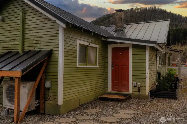 Convenient back entrance off mudroom. Newer metal roof, chimney cap and energy efficient mini split to keep the space comfortable during every stay. Easy care side planters provide lush greenery, seasonal color and enhanced curb appeal.