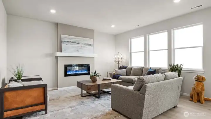 Spacious great room with an electric fireplace and plenty of windows. Picture for representational purposes only, colors and features may vary. Spacious great room with an electric fireplace and plenty of windows. Picture for representational purposes only, colors and features may vary.