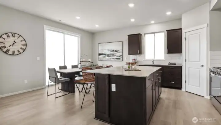 Island kitchen with a walk-in pantry and slider to the back patio. Picture for representational purposes only, colors and features may vary. Island kitchen with a walk-in pantry and slider to the back patio. Picture for representational purposes only, colors and features may vary.