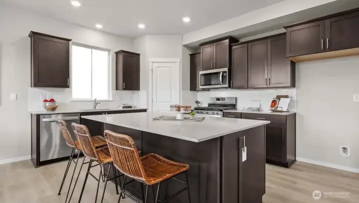 Slab quartz countertops and full height tile backsplash keep the kitchen stylish and easy to maintain. Picture for representational purposes only, colors and features may vary. Slab quartz countertops and full height tile backsplash keep the kitchen stylish and easy to maintain. Picture for representational purposes only, colors and features may vary.